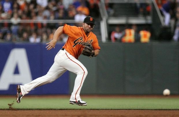 Jul 25, 2014; San Francisco, CA, USA; San Francisco Giants second baseman Dan Uggla (22) chases a ground ball in the fourth inning of their MLB baseball game with the Los Angeles Dodgers at AT&T Park. Mandatory Credit: Lance Iversen-USA TODAY Sports