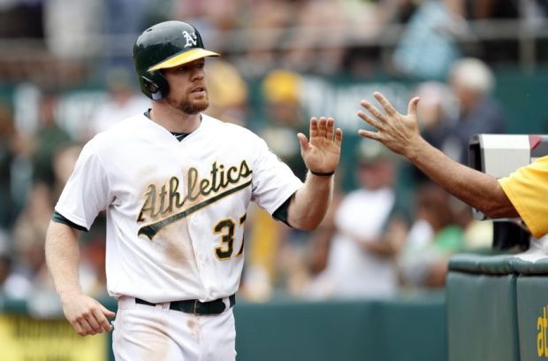Sep 21, 2014; Oakland, CA, USA; Oakland Athletics left fielder Brandon Moss (37) is congratulated after he scored  in the fifth inning against the Philadelphia Phillies at O.co Coliseum. Mandatory Credit: Bob Stanton-USA TODAY Sports