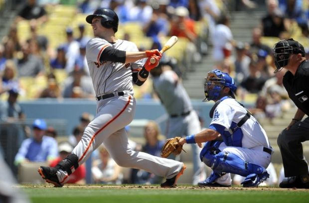 May 10, 2014; Los Angeles, CA, USA; San Francisco Giants first baseman Buster Posey (28) hits a single in the first inning against the Los Angeles Dodgers at Dodger Stadium. Mandatory Credit: Gary Vasquez-USA TODAY Sports