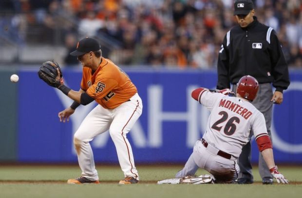 Jul 11, 2014; San Francisco, CA, USA; San Francisco Giants second baseman Joe Panik (12) gets the ball too late as Arizona Diamondbacks catcher Miguel Montero (26) slides into second after hitting a double during the fourth inning at AT&T Park. Mandatory Credit: Bob Stanton-USA TODAY Sports