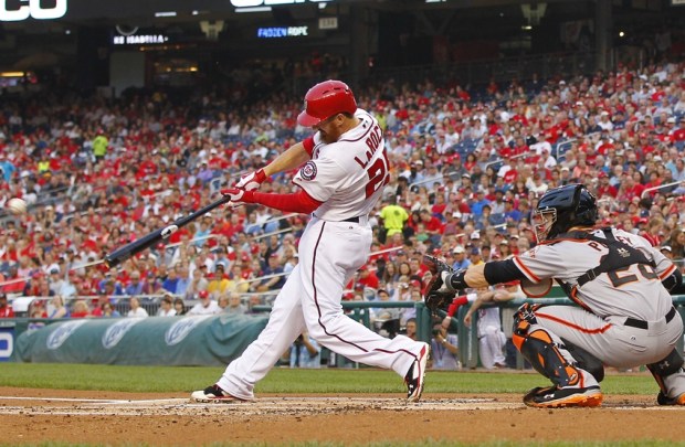 Aug 22, 2014; Washington, DC, USA; Washington Nationals first baseman Adam LaRoche (25) singles in front of San Francisco Giants catcher Buster Posey (28) in the first inning at Nationals Park. Mandatory Credit: Geoff Burke-USA TODAY Sports