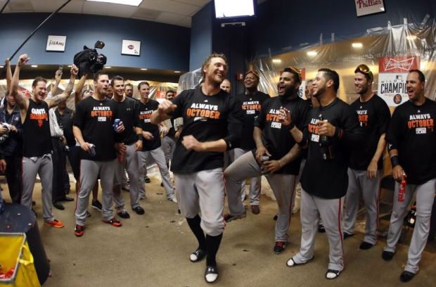 Oct 1, 2014; Pittsburgh, PA, USA; San Francisco Giants right fielder Hunter Pence (center) celebrates with teammates in the clubhouse after defeating the Pittsburgh Pirates in the 2014 National League Wild Card playoff baseball game at PNC Park. The Giants won 8-0. Mandatory Credit: Charles LeClaire-USA TODAY Sports