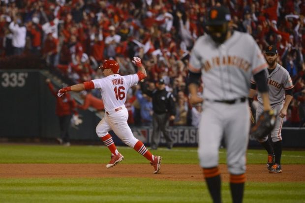 Oct 12, 2014; St. Louis, MO, USA; St. Louis Cardinals second baseman Kolten Wong (16) reacts after hitting the game-winning solo home run off of San Francisco Giants relief pitcher Sergio Romo (right) in the 9th inning in game two of the 2014 NLCS playoff baseball game at Busch Stadium. Mandatory Credit: Jeff Curry-USA TODAY Sports