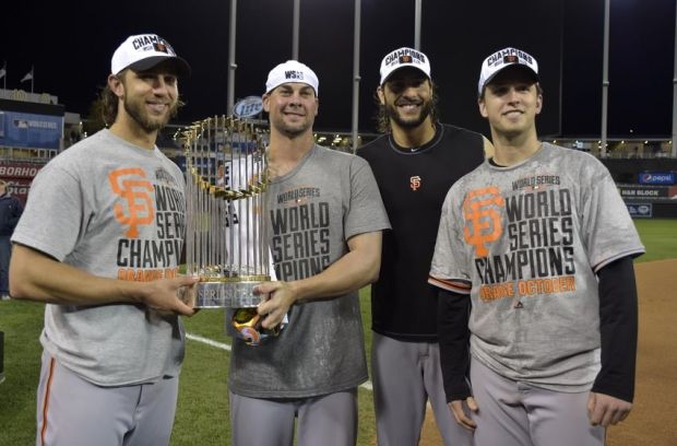 Oct 29, 2014; Kansas City, MO, USA; San Francisco Giants players from left Madison Bumgarner , Ryan Vogelsong , Michael Morse and Buster Posey pose with the Commissioners Trophy after game seven of the 2014 World Series against the Kansas City Royals at Kauffman Stadium. Mandatory Credit: Denny Medley-USA TODAY Sports