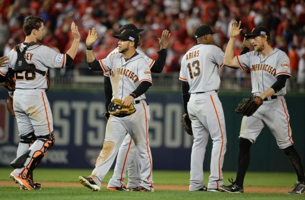 Oct 3, 2014; Washington, DC, USA; San Francisco Giants players celebrate their 3-2 win in game one of the 2014 NLDS playoff baseball game against the Washington Nationals at Nationals Park. Mandatory Credit: H.Darr Beiser-USA TODAY Sports