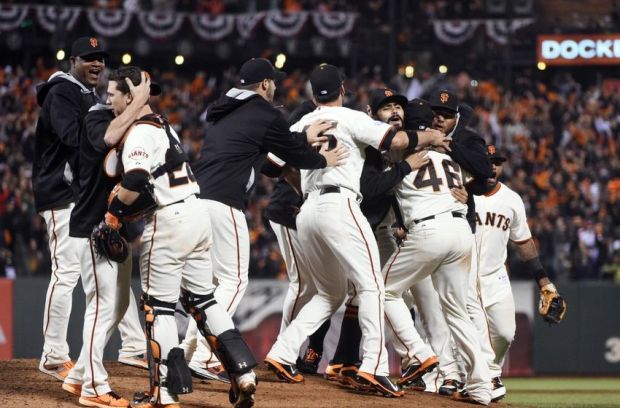 Oct 7, 2014; San Francisco, CA, USA; San Francisco Giants players celebrate on the field with relief pitcher Santiago Casilla (46) after defeating the Washington Nationals in game four of the 2014 NLDS baseball playoff game at AT&T Park. The Giants won the series three games to one and advance to the NLCS. Mandatory Credit: Kyle Terada-USA TODAY Sports