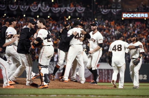 Oct 7, 2014; San Francisco, CA, USA; San Francisco Giants players celebrate on the field with relief pitcher Santiago Casilla (46) after defeating the Washington Nationals in game four of the 2014 NLDS baseball playoff game at AT&T Park. The Giants won the series three games to one and advance to the NLCS. Mandatory Credit: Kyle Terada-USA TODAY Sports