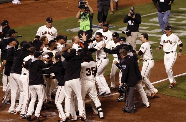 Oct 16, 2014; San Francisco, CA, USA; San Francisco Giants left fielder Travis Ishikawa (45) celebrates with teammates after hitting a walk off three run home run against the St. Louis Cardinals during the ninth inning of game five of the 2014 NLCS playoff at AT&T Park.Mandatory Credit: Kelley L Cox-USA TODAY Sports