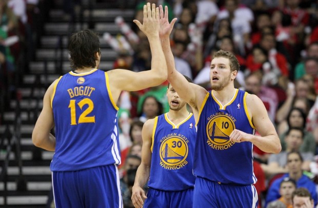Mar 17, 2013; Houston, TX, USA; Golden State Warriors power forward David Lee (10) is congratulated by Andrew Bogut (12) during the fourth quarter against the Houston Rockets at Toyota Center. Mandatory Credit: Troy Taormina-USA TODAY Sports