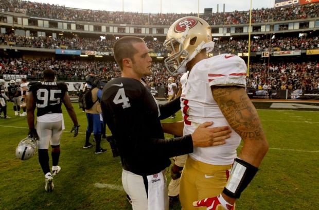 Dec 7, 2014; Oakland, CA, USA; Oakland Raiders quarterback Derek Carr (4) talks with San Francisco 49ers quarterback Colin Kaepernick (7) after the game at O.co Coliseum. The Raiders defeated the 49ers 24-13. Mandatory Credit: Cary Edmondson-USA TODAY Sports