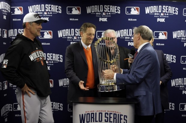 Oct 29, 2014; Kansas City, MO, USA; MLB commissioner Bud Selig (right) presents San Francisco Giants manager Bruce Bochy (left) , chief executive officer Larry Baer (middle) and general manager Brian Sabean with the Commissioners Trophy after game seven of the 2014 World Series against the Kansas City Royals at Kauffman Stadium. Mandatory Credit: Charlie Neibergall/Pool Photo via USA TODAY Sports