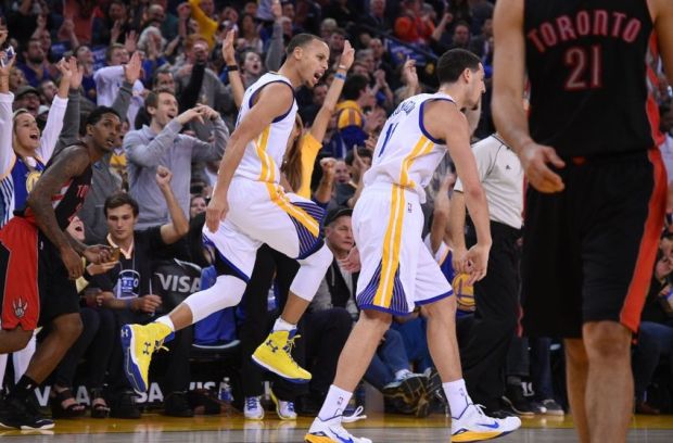January 2, 2015; Oakland, CA, USA; Golden State Warriors guard Stephen Curry (30) congratulates guard Klay Thompson (11) for making a three-point basket during the third quarter against the Toronto Raptors at Oracle Arena. The Warriors defeated the Raptors 126-105. Mandatory Credit: Kyle Terada-USA TODAY Sports