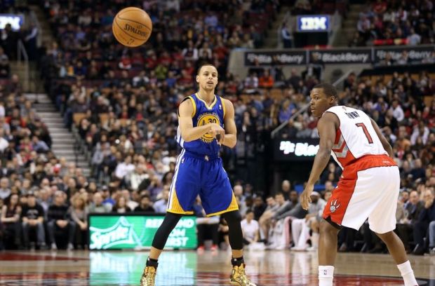 Mar 2, 2014; Toronto, Ontario, CAN; Golden State Warriors point guard Stephen Curry (30) passes the ball as Toronto Raptors point guard Kyle Lowry (7) looks on at Air Canada Centre. The Raptors beat the Warriors 104-98. Mandatory Credit: Tom Szczerbowski-USA TODAY Sports