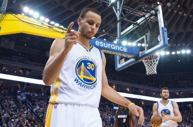 January 14, 2015; Oakland, CA, USA; Golden State Warriors guard Stephen Curry (30) celebrates after a basket against the Miami Heat during the third quarter at Oracle Arena. The Warriors defeated the Heat 104-89. Mandatory Credit: Kyle Terada-USA TODAY Sports
