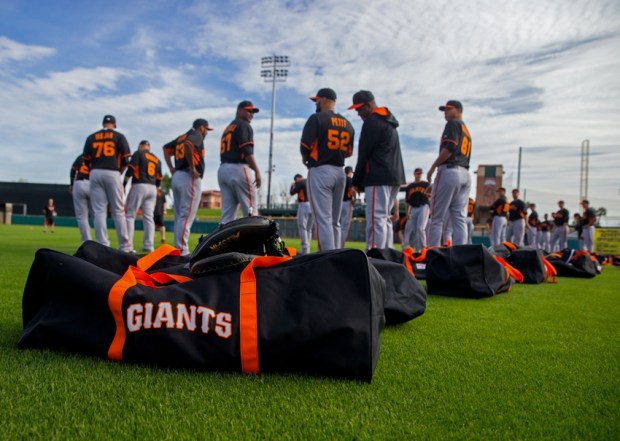 Feb 19, 2015; Glendale, AZ, USA; San Francisco Giants players prepare to stretch on the field as their bags sit in the grass during spring training practice at Scottsdale Stadium. Mandatory Credit: Mark J. Rebilas-USA TODAY Sports