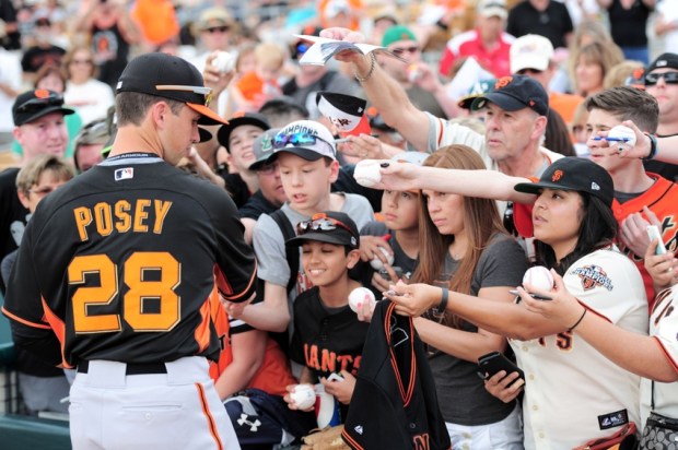 Mar 12, 2015; Phoenix, AZ, USA; San Francisco Giants catcher Buster Posey (28) signs autographs for fans prior to a game against the Chicago White Sox at Camelback Ranch. Mandatory Credit: Joe Camporeale-USA TODAY Sports
