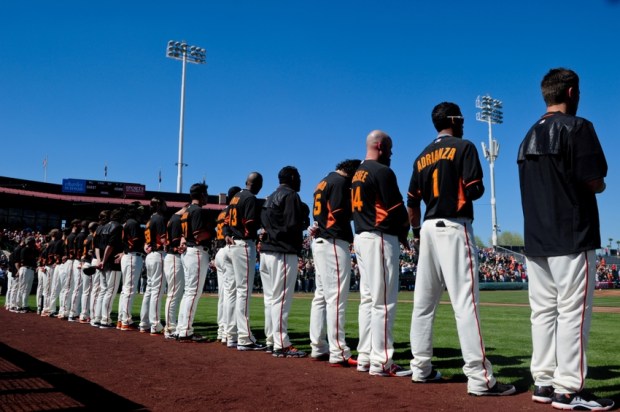 Mar 4, 2015; Scottsdale, AZ, USA; The San Francisco Giants look on during the National Anthem before a spring training baseball game against the Oakland Athletics at Scottsdale Stadium. Mandatory Credit: Matt Kartozian-USA TODAY Sports