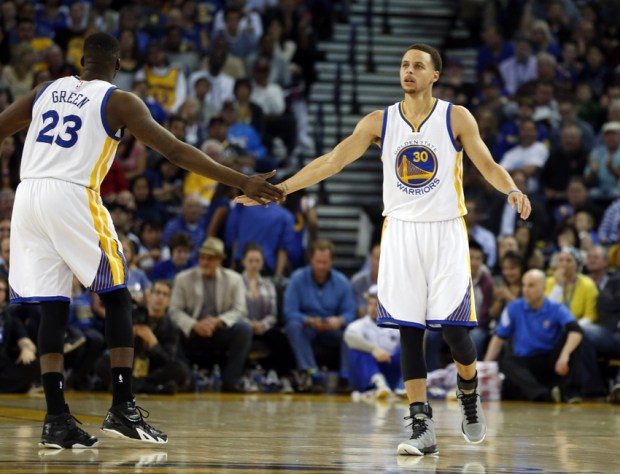 Mar 20, 2015; Oakland, CA, USA; Golden State Warriors forward Draymond Green (23) congratulates guard Stephen Curry (30) after Curry scored during the third quarter at Oracle Arena. Mandatory Credit: Bob Stanton-USA TODAY Sports