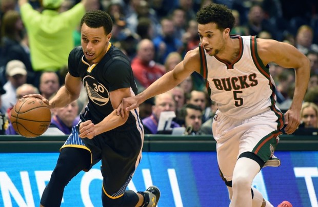 Mar 28, 2015; Milwaukee, WI, USA;  Golden State Warriors guard Stephen Curry (30) drives for the basket against Milwaukee Bucks guard Michael Carter-Williams (5) in the first quarter at BMO Harris Bradley Center. Mandatory Credit: Benny Sieu-USA TODAY Sports