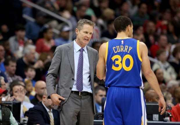Feb 6, 2015; Atlanta, GA, USA; Golden State Warriors head coach Steve Kerr talks with guard Stephen Curry (30) in the third quarter of their game against the Atlanta Hawks at Philips Arena. The Hawks won 124-116. Mandatory Credit: Jason Getz-USA TODAY Sports