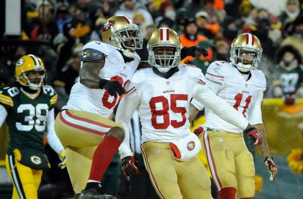 Jan 5, 2014; Green Bay, WI, USA;  San Francisco 49ers tight end Vernon Davis (85) celebrates a touchdown with wide receiver Anquan Boldin (81) and wide receiver Quinton Patton (11) in the 4th quarter as Green Bay Packers cornerback Tramon Williams (38) looks on during the 2013 NFC wild card playoff football game at Lambeau Field.  The 49ers beat the Packers 23-20. Mandatory Credit: Benny Sieu-USA TODAY Sports