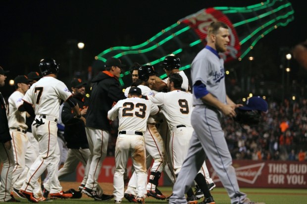 Apr 22, 2015; San Francisco, CA, USA; San Francisco Giants second baseman Joe Panik (12) is mobbed by his teammates after he hit the game winning hit in the ninth inning against the Los Angeles Dodgers at AT&T Park. Mandatory Credit: Lance Iversen-USA TODAY Sports, giants win 3-2.